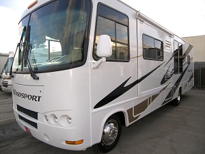 White RV after a paint job decorated with new black and brown decals.