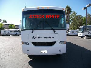Front of white Hurricane RV with 'stock photo' written in red on the windows. 